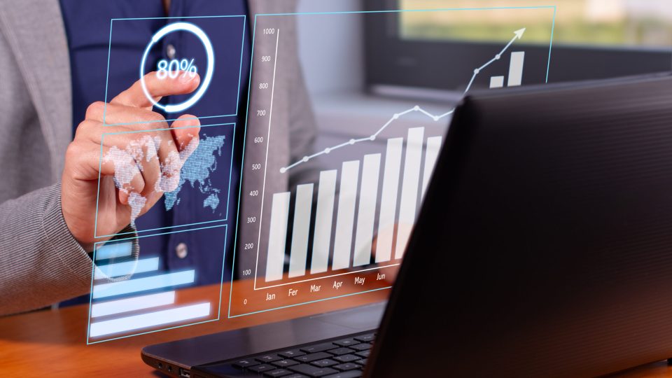 Successful Business Trends: Businessman Analyzing Rising Graphs in Modern Office